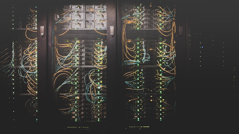 Network switches and cables in a data centre, blue LED light