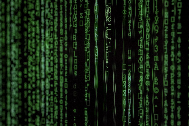 Laptop screen displaying cascading lines of code